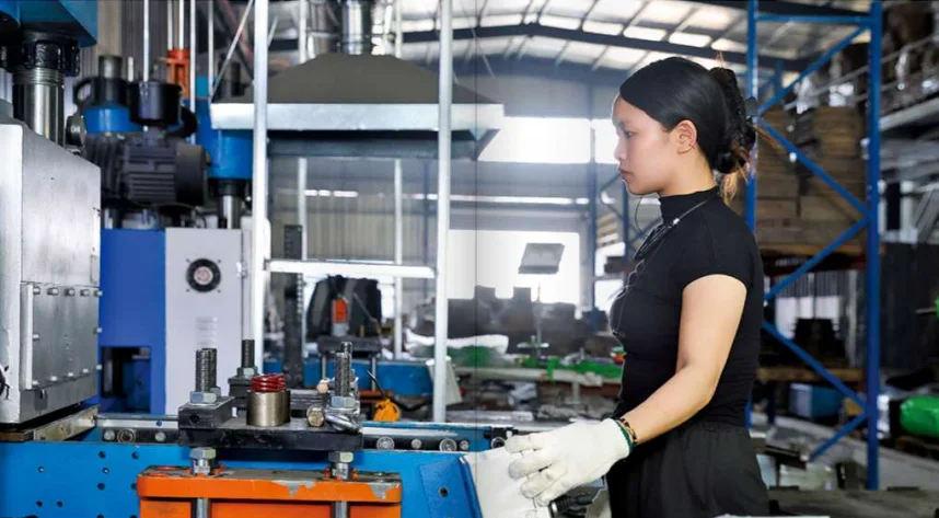 Operator at a hydraulic moulding press on the rubber and TPU line